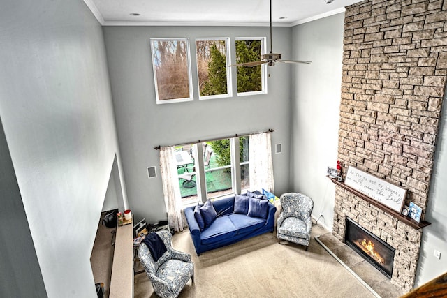 184 Primrose Ln, Bartlett, IL 60103 - living room featuring healthy amount of natural light, ornamental molding, a fireplace, a ceiling fan, and carpet