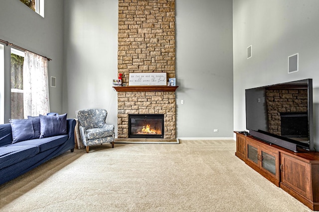 184 Primrose Ln, Bartlett, IL 60103 - living area with a stone fireplace, a high ceiling, carpet floors, and healthy amount of natural light