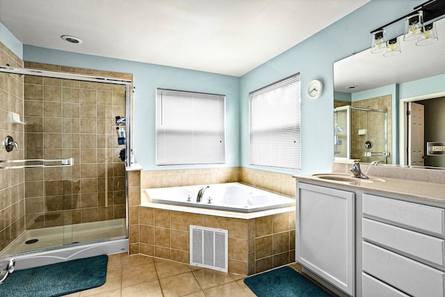 184 Primrose Ln, Bartlett, IL 60103 - full bathroom featuring tile patterned floors, a stall shower, a garden tub, and vanity