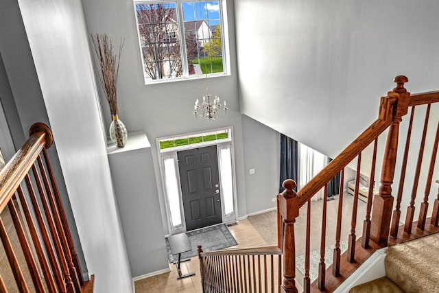 184 Primrose Ln, Bartlett, IL 60103 - tiled entrance foyer with plenty of natural light, a high ceiling, stairs, and a chandelier