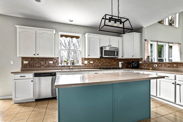 184 Primrose Ln, Bartlett, IL 60103 - kitchen with stainless steel appliances, light tile patterned floors, and white cabinets