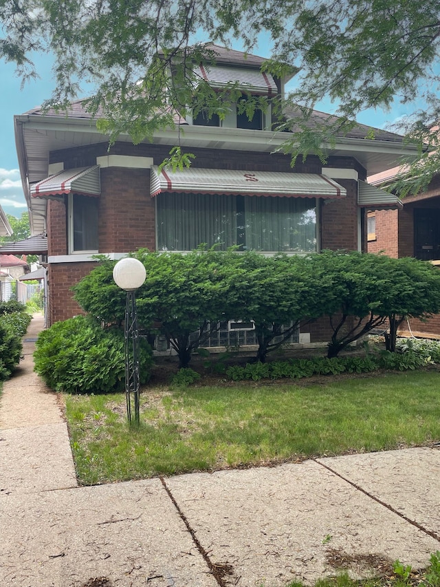 9412 S Elizabeth St, Chicago, IL 60620 - view of front facade featuring brick siding and a front yard