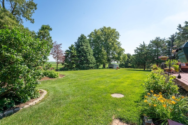 1392 Red Brick Rd, Dixon, IL 61021 - view of grassy yard featuring a storage shed and a wooden deck
