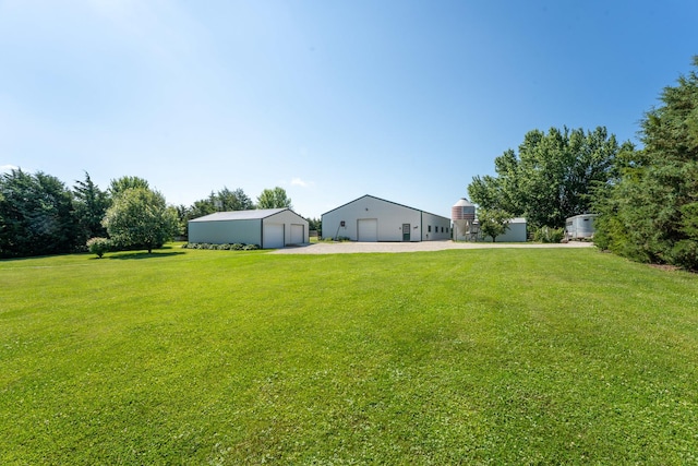 1392 Red Brick Rd, Dixon, IL 61021 - view of grassy yard featuring a garage, an outbuilding, and a pole building