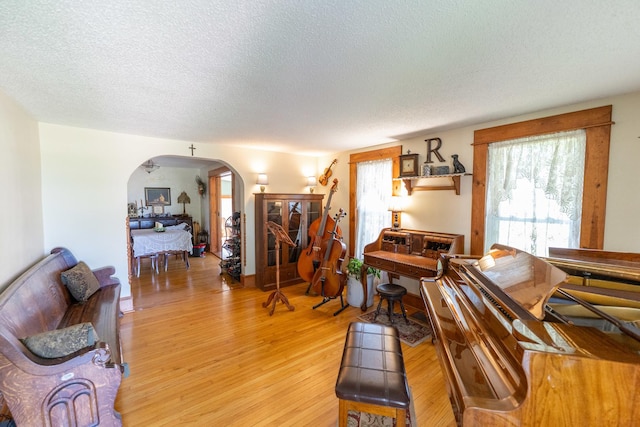 1392 Red Brick Rd, Dixon, IL 61021 - living room with arched walkways, a textured ceiling, and light wood-type flooring