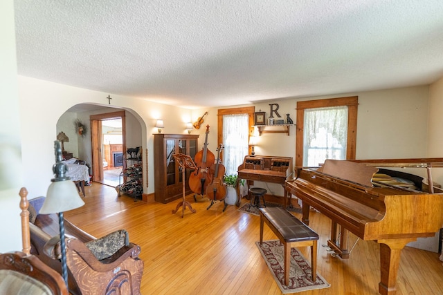 1392 Red Brick Rd, Dixon, IL 61021 - living area with arched walkways, a textured ceiling, and light wood-type flooring