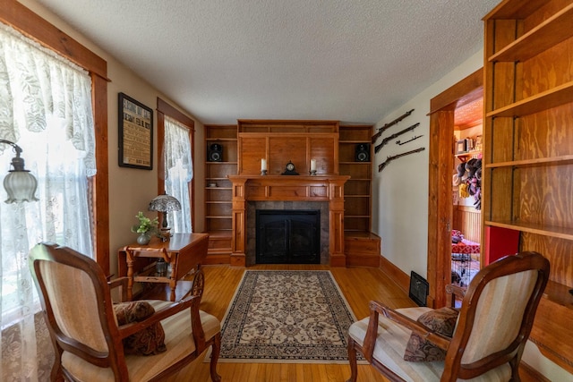 1392 Red Brick Rd, Dixon, IL 61021 - living area with a textured ceiling, a fireplace with flush hearth, and wood finished floors