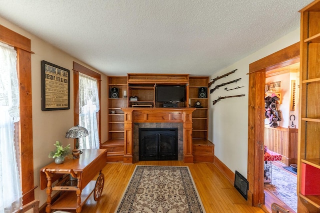 1392 Red Brick Rd, Dixon, IL 61021 - living area with a textured ceiling, a fireplace, and light wood-style floors