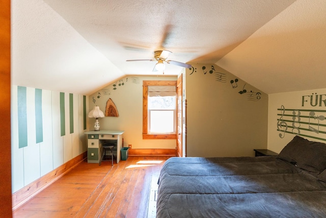 1392 Red Brick Rd, Dixon, IL 61021 - bedroom featuring light wood finished floors, lofted ceiling, ceiling fan, and a textured ceiling
