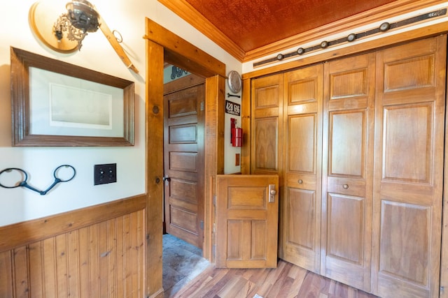 1392 Red Brick Rd, Dixon, IL 61021 - hallway with wainscoting, ornamental molding, light wood-style flooring, and wooden walls