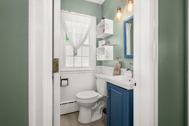 1050 N 8th St, Rochelle, IL 61068 - half bathroom with wainscoting, vanity, and baseboard heating