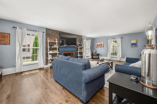 1050 N 8th St, Rochelle, IL 61068 - living room with healthy amount of natural light, wood finished floors, and a brick fireplace