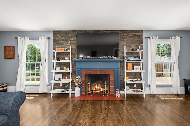 1050 N 8th St, Rochelle, IL 61068 - living area with a brick fireplace, wood finished floors, and healthy amount of natural light