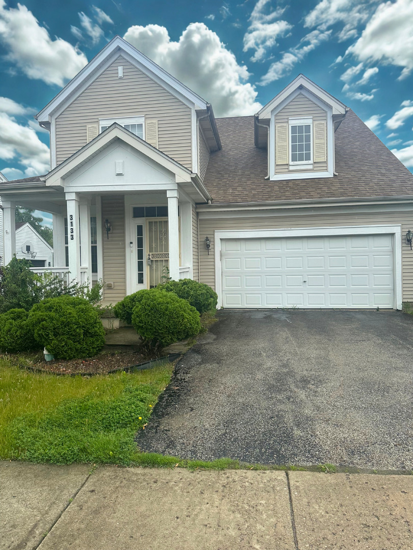 3133 Heritage Blvd, Matteson, IL 60443 - view of front of house with driveway, an attached garage, covered porch, and a shingled roof