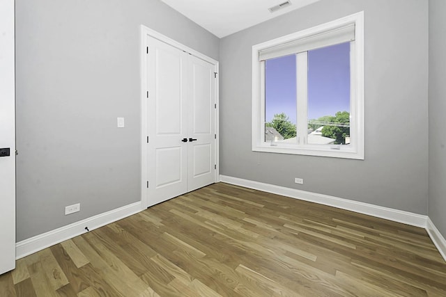 5010 W Lawrence Ave Unit 3B, Chicago, IL 60630 - unfurnished bedroom featuring wood finished floors and a closet