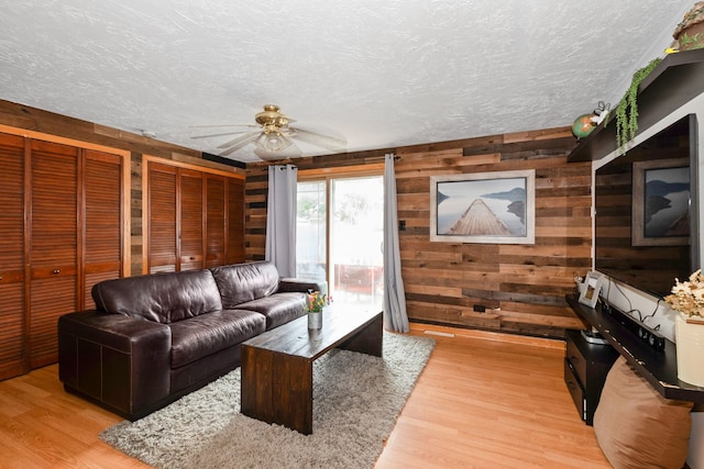 4631W W 88th St, Hometown, IL 60456 - living area with a ceiling fan, wooden walls, light wood-type flooring, and a textured ceiling