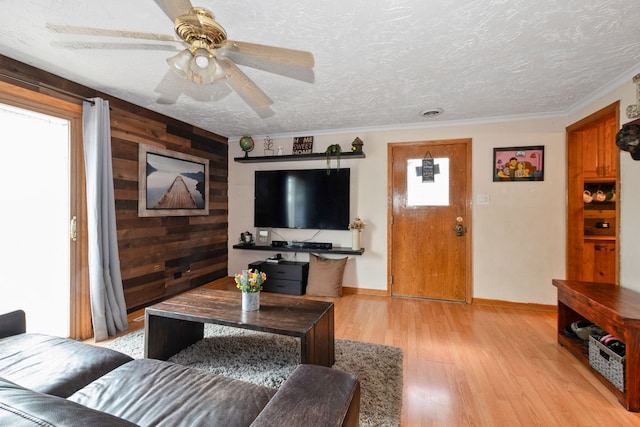 4631W W 88th St, Hometown, IL 60456 - living area with healthy amount of natural light, light wood finished floors, a ceiling fan, wooden walls, and a textured ceiling