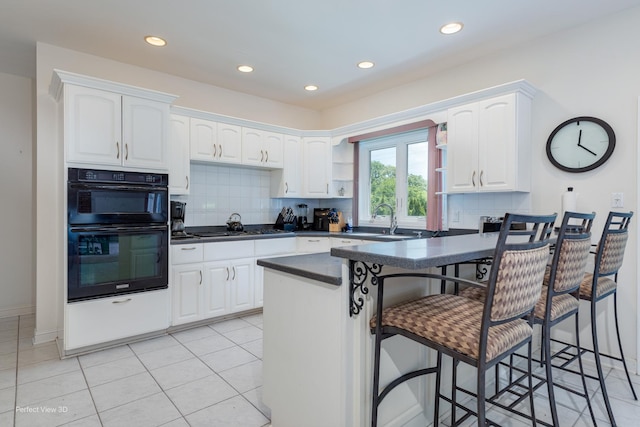 20825 Brookside Blvd, Olympia Fields, IL 60461 - kitchen featuring dark countertops, a peninsula, open shelves, white cabinets, and recessed lighting