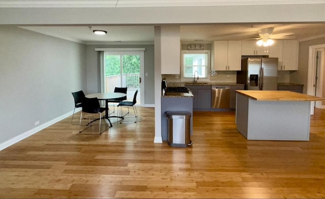 408 Sauk Trl, Park Forest, IL 60466 - kitchen with stainless steel appliances, wood counters, light wood-style flooring, white cabinetry, and ornamental molding