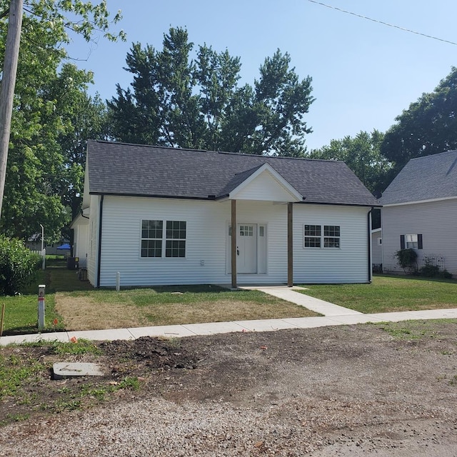 409 E Buckner St, Tuscola, IL 61953 - view of front of property featuring a front yard and a shingled roof