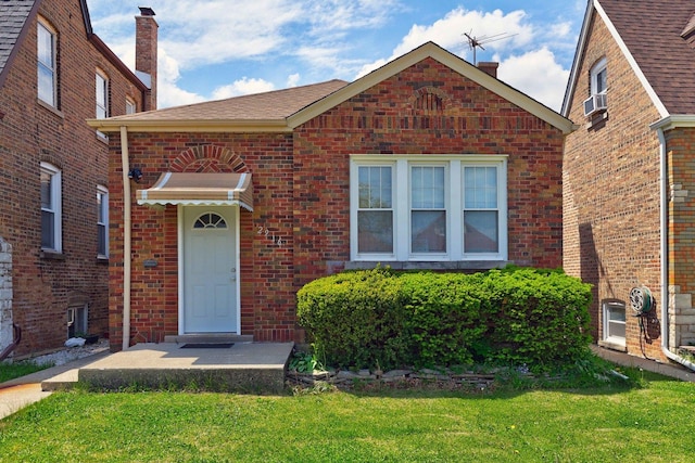 2916 N Melvina Ave, Chicago, IL 60634 - property entrance with a yard, brick siding, and a chimney