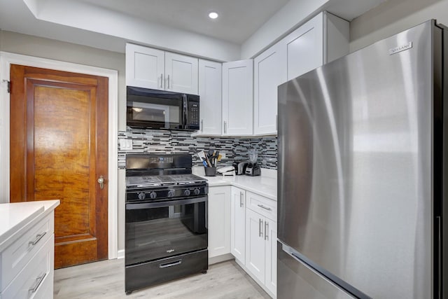 2916 N Melvina Ave, Chicago, IL 60634 - kitchen with black appliances, light countertops, light wood-type flooring, white cabinetry, and backsplash