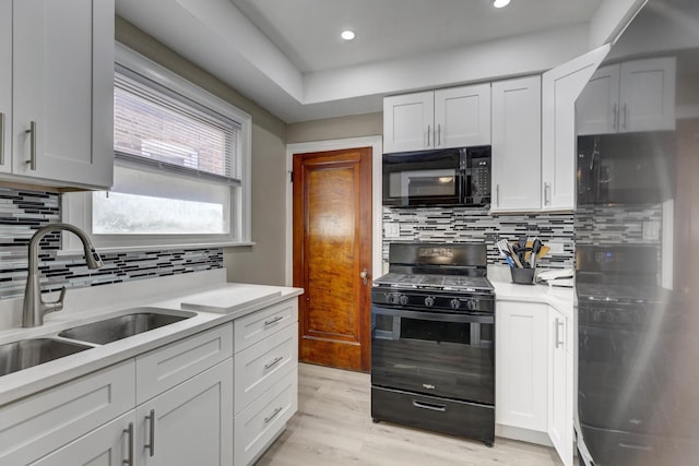 2916 N Melvina Ave, Chicago, IL 60634 - kitchen with black appliances, decorative backsplash, light countertops, light wood finished floors, and recessed lighting