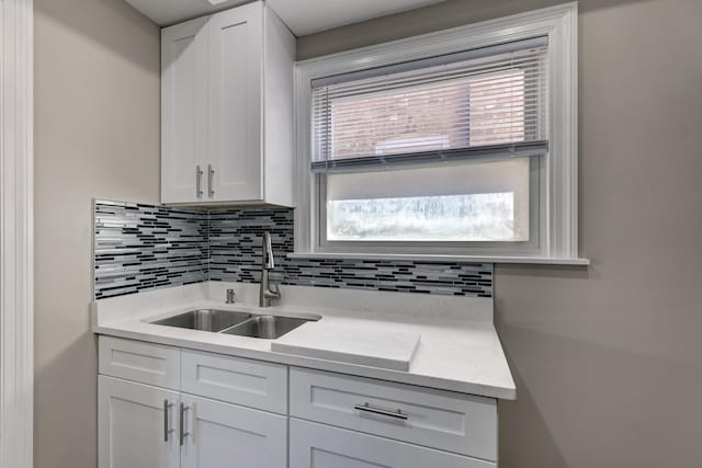 2916 N Melvina Ave, Chicago, IL 60634 - kitchen with decorative backsplash, white cabinetry, and light stone counters