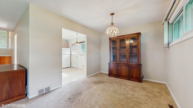 80 E Fremont Ave, Des Plaines, IL 60016 - unfurnished dining area featuring a chandelier and light carpet