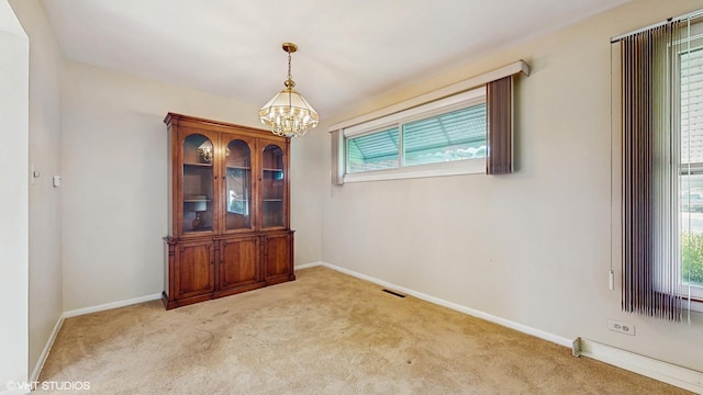 80 E Fremont Ave, Des Plaines, IL 60016 - unfurnished room with healthy amount of natural light, a chandelier, and light carpet