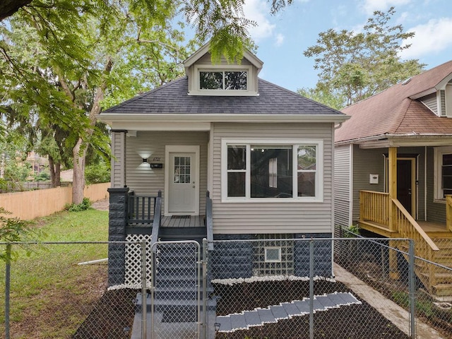 6721 S Ada St, Chicago, IL 60636 - view of front of home with a fenced front yard and roof with shingles
