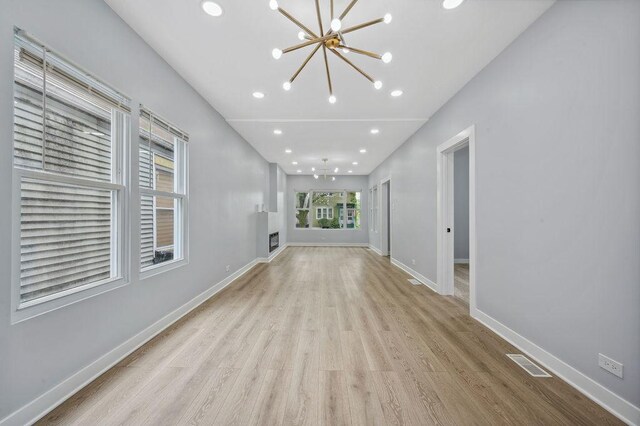 6721 S Ada St, Chicago, IL 60636 - unfurnished living room featuring a chandelier, wood finished floors, and recessed lighting