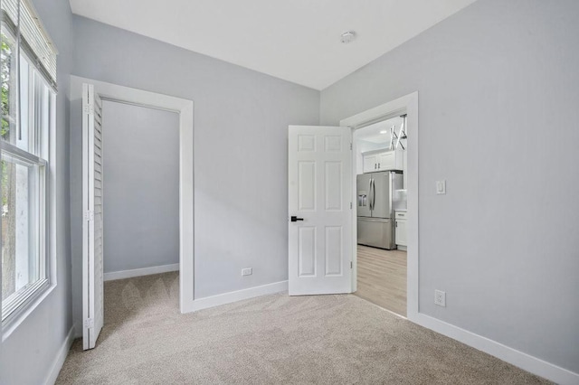 6721 S Ada St, Chicago, IL 60636 - unfurnished bedroom with stainless steel fridge with ice dispenser, light colored carpet, a closet, and a walk in closet