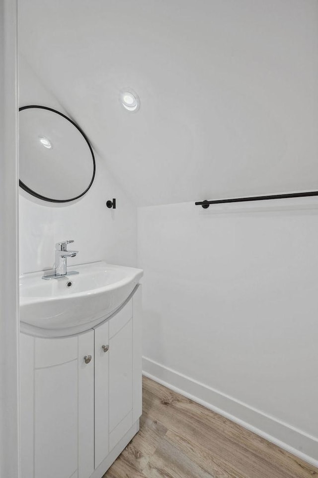 6721 S Ada St, Chicago, IL 60636 - bathroom featuring vanity, wood finished floors, and vaulted ceiling