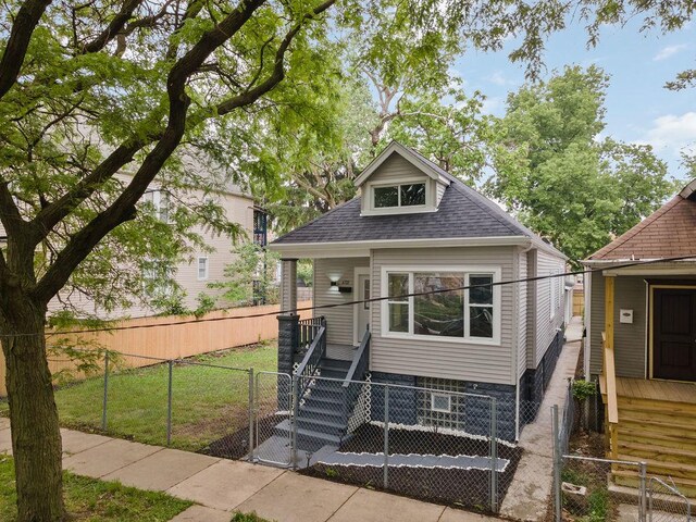 6721 S Ada St, Chicago, IL 60636 - view of front facade featuring a gate, a porch, a shingled roof, and a fenced front yard