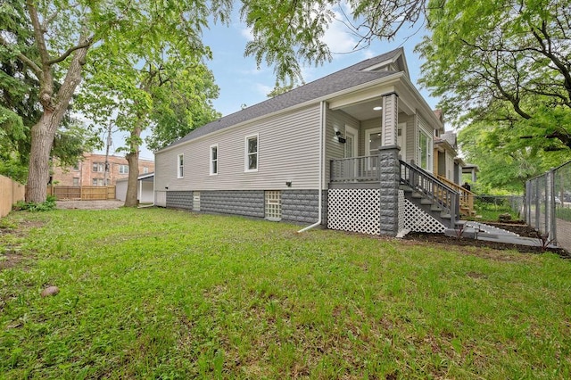 6721 S Ada St, Chicago, IL 60636 - rear view of property featuring stairs, a fenced backyard, covered porch, and a shingled roof