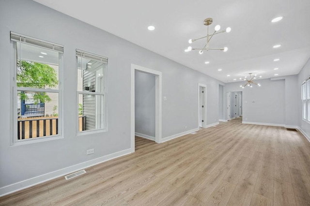 6721 S Ada St, Chicago, IL 60636 - unfurnished living room featuring a chandelier, light wood-type flooring, and recessed lighting