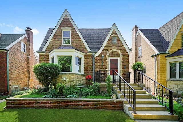 3010 Wisconsin Ave, Berwyn, IL 60402 - tudor house with a shingled roof, brick siding, stone siding, and a front lawn