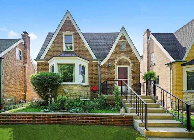 3010 Wisconsin Ave, Berwyn, IL 60402 - tudor home with roof with shingles, brick siding, and a front yard