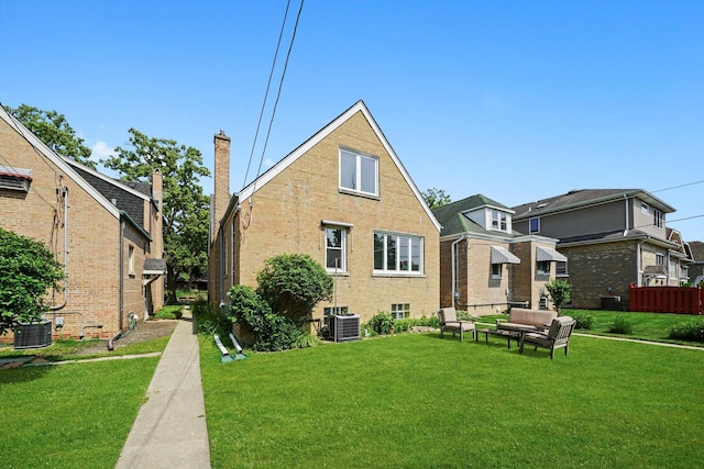 3010 Wisconsin Ave, Berwyn, IL 60402 - back of property with a yard, an outdoor living space, brick siding, and a chimney
