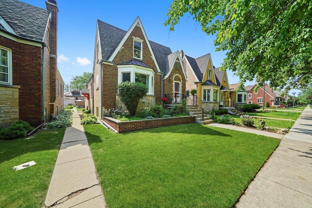 3010 Wisconsin Ave, Berwyn, IL 60402 - tudor home with a front yard, brick siding, and a chimney