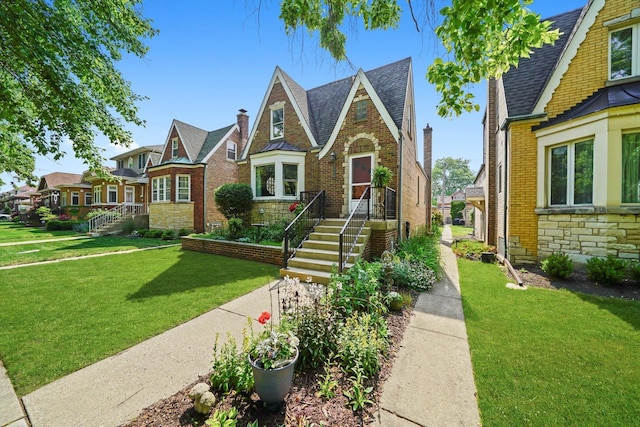 3010 Wisconsin Ave, Berwyn, IL 60402 - tudor home featuring stone siding, a front lawn, roof with shingles, brick siding, and a residential view