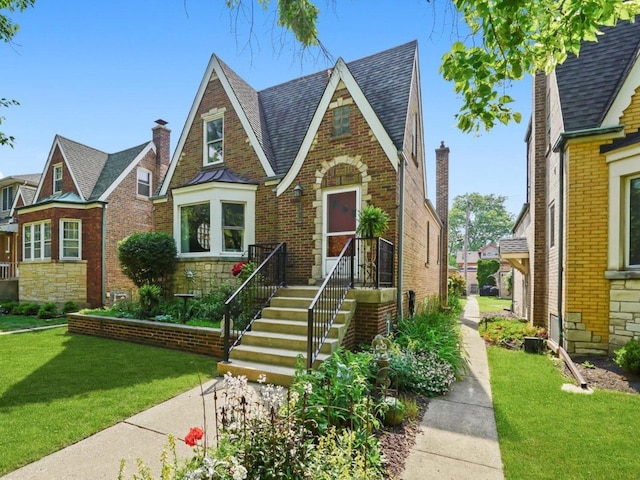 3010 Wisconsin Ave, Berwyn, IL 60402 - tudor house with a front yard, brick siding, stone siding, and a shingled roof