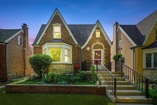 3010 Wisconsin Ave, Berwyn, IL 60402 - tudor-style house featuring roof with shingles, brick siding, and stone siding