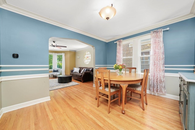 3010 Wisconsin Ave, Berwyn, IL 60402 - dining space featuring arched walkways, ornamental molding, light wood-type flooring, and ceiling fan