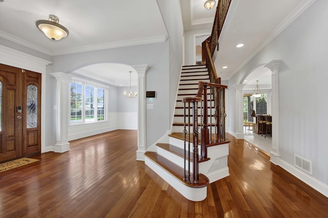 445 E Crescent Ave, Elmhurst, IL 60126 - foyer featuring arched walkways, plenty of natural light, wood finished floors, decorative columns, and crown molding