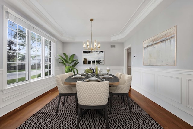 445 E Crescent Ave, Elmhurst, IL 60126 - dining area featuring a chandelier, a raised ceiling, dark wood-style floors, ornamental molding, and a wainscoted wall