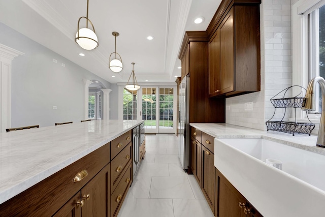 445 E Crescent Ave, Elmhurst, IL 60126 - kitchen with ornate columns, decorative backsplash, hanging light fixtures, recessed lighting, and light stone countertops
