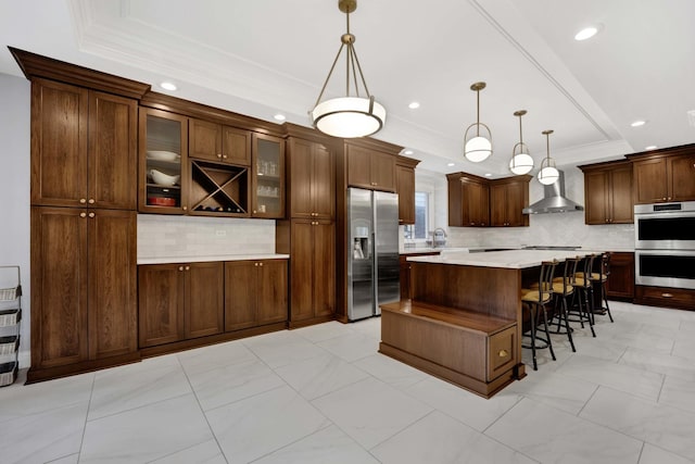 445 E Crescent Ave, Elmhurst, IL 60126 - kitchen featuring stainless steel appliances, a tray ceiling, wall chimney exhaust hood, tasteful backsplash, and light countertops