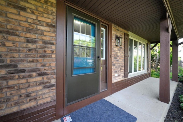 590 Woodcrest Ct, Carol Stream, IL 60188 - view of exterior entry with brick siding and a porch